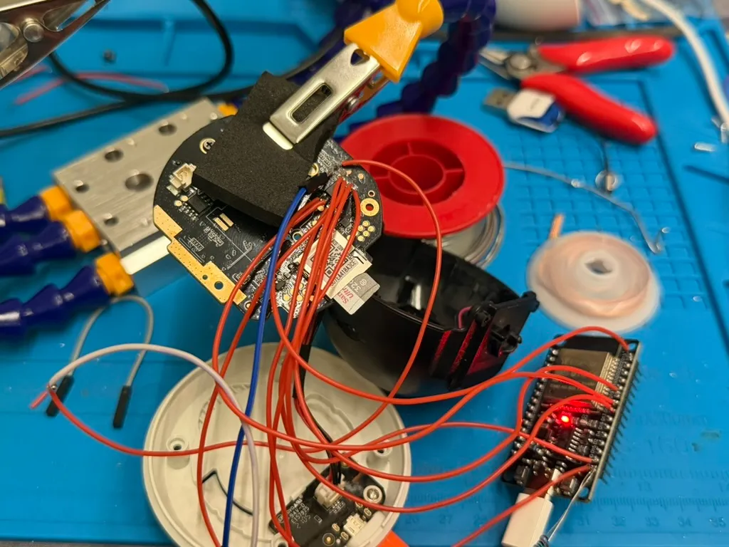 Powered up and talking: the ESP32's LED on, leads into the board in the clamp