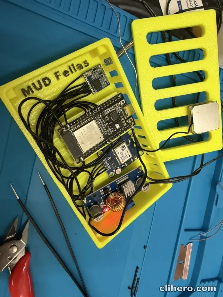 The open case with all parts in place: LoRa module, ESP32, NEO-6M GPS and the buck converter with its red power LED lit, the GPS patch antenna resting on the lid