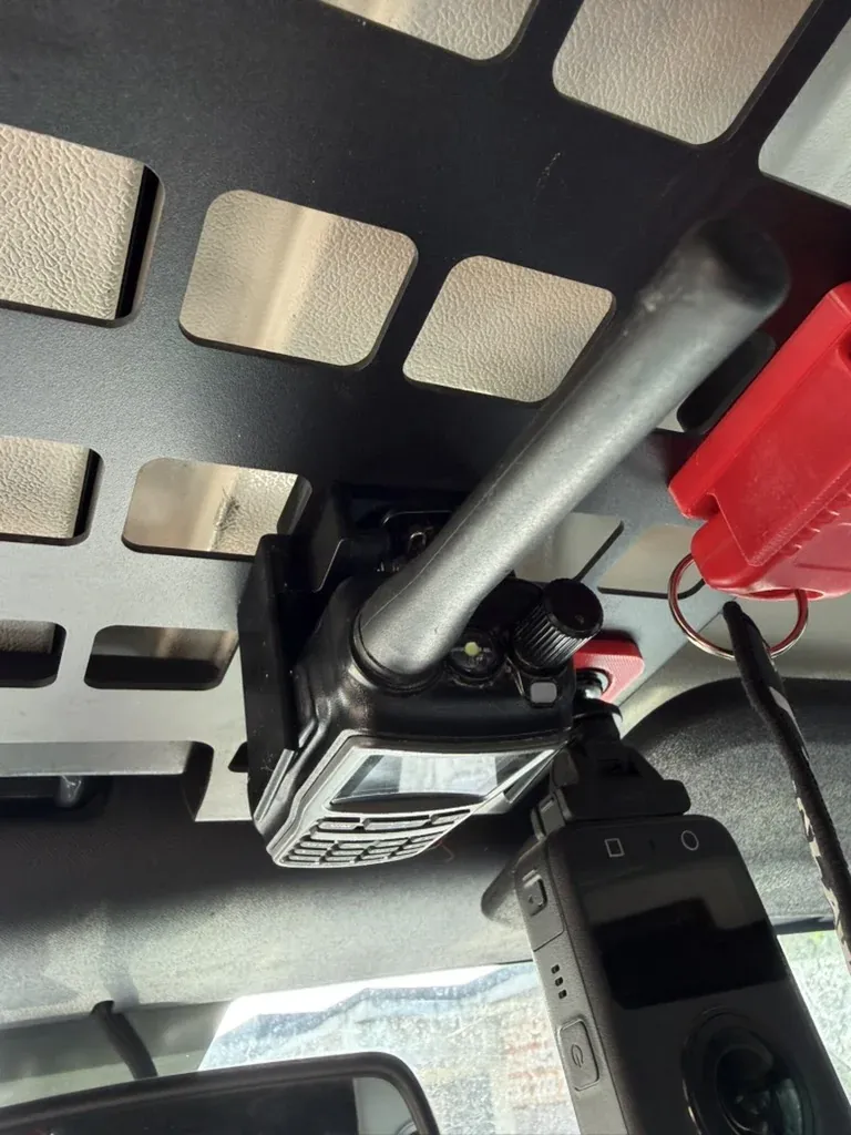 The Baofeng seated in the printed clip on the panel